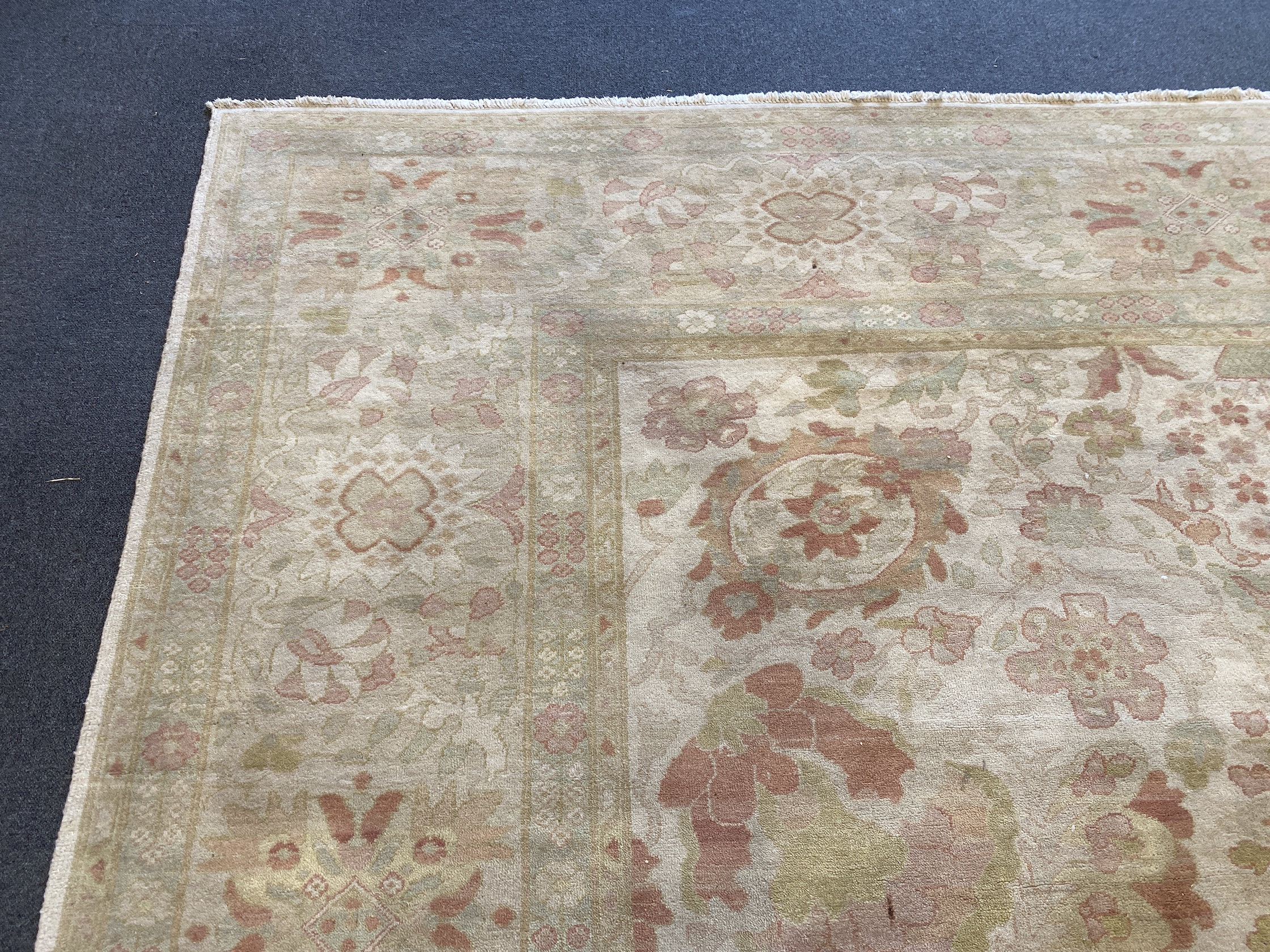 A large Indian ivory ground carpet, 445 x 372cm